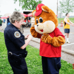 Shoney's Bear getting advice from a Nashville police officer.