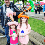Children wearing balloon hats at the 5k festival.